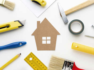 Cardboard House Surrounded By Repair Tools